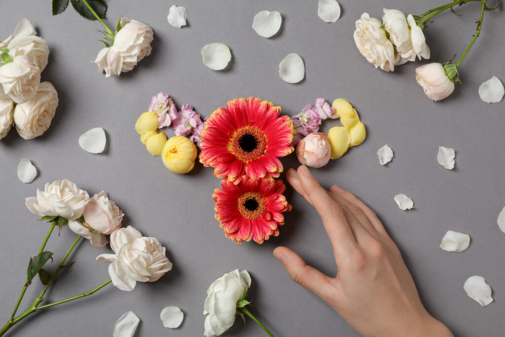 Uterus Flowers Female Hand Gray Background Top View 1024x683