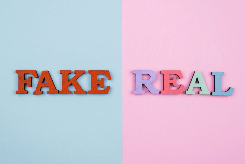 How to Identify Fake vs Real Supplements & Cosmetics: A Consumer’s Guide to Buying Safely fake real news concept top view (1)