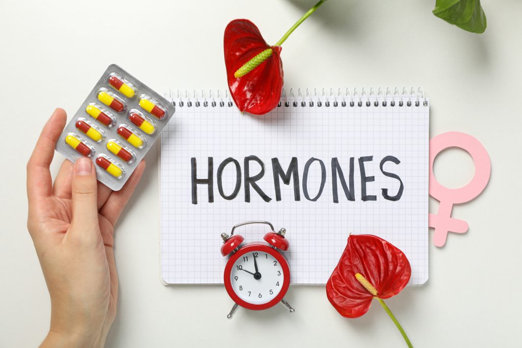 Concept of women's health and understanding hormones with pills and medical symbols.