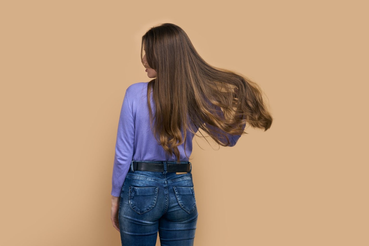 Woman with healthy, shiny hair representing hormonal balance and scalp vitality.