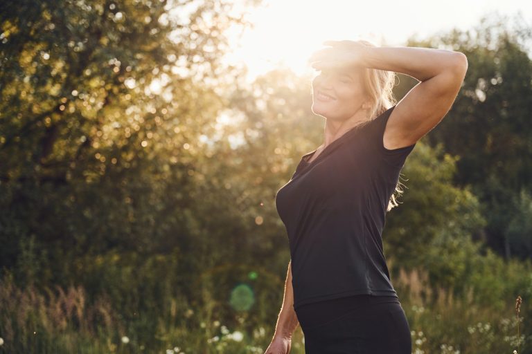 Confident midlife woman in natural light representing hormonal balance and healthy aging